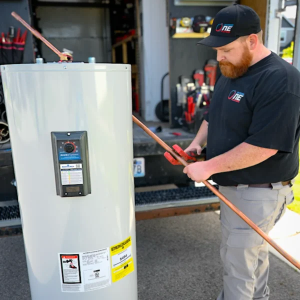 Division One Plumbing service tech installing water heater