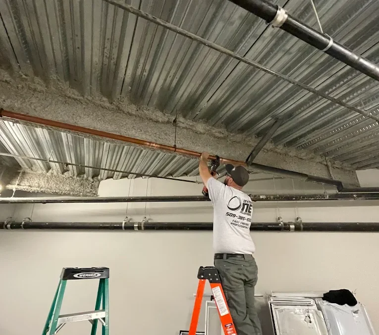 Division One Plumbing technician installing copper piping in a commercial building in Spokane County, WA